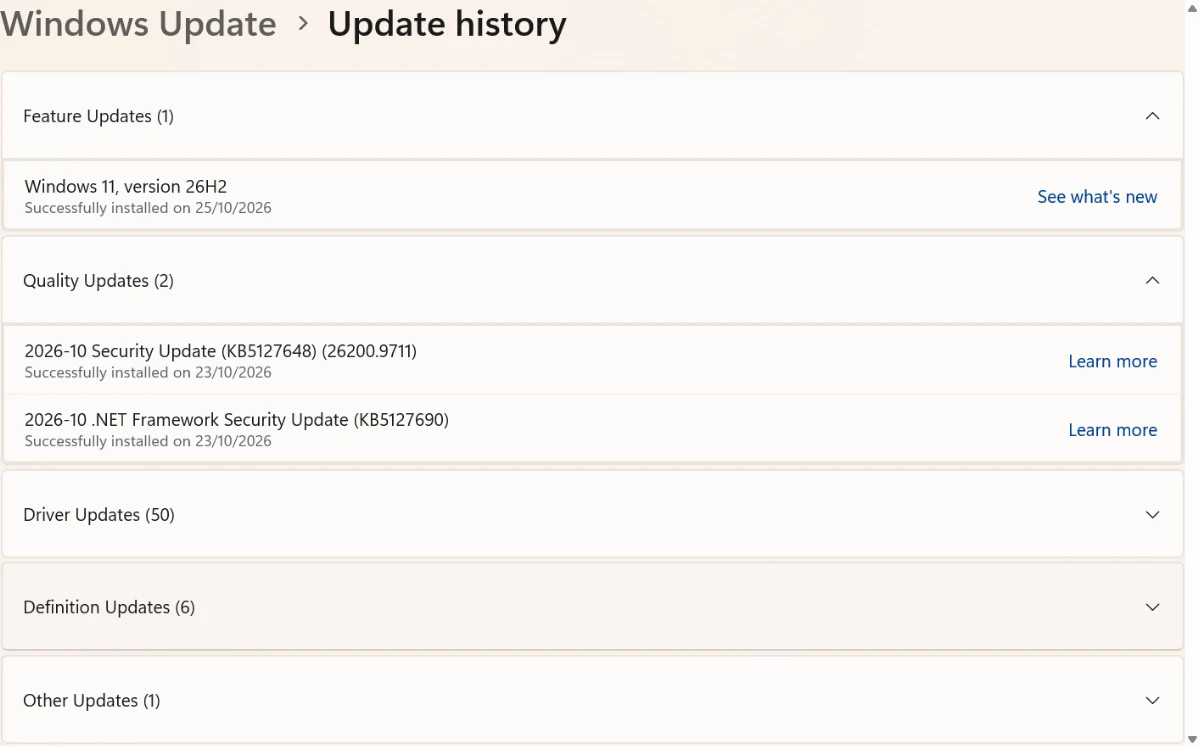 Windows 11 Update history showing 2026-10 Security Update KB5127648 (26200.9711) successfully installed on 23/10/2026 and the Windows 11 version 26H2 feature update installed on 25/10/2026